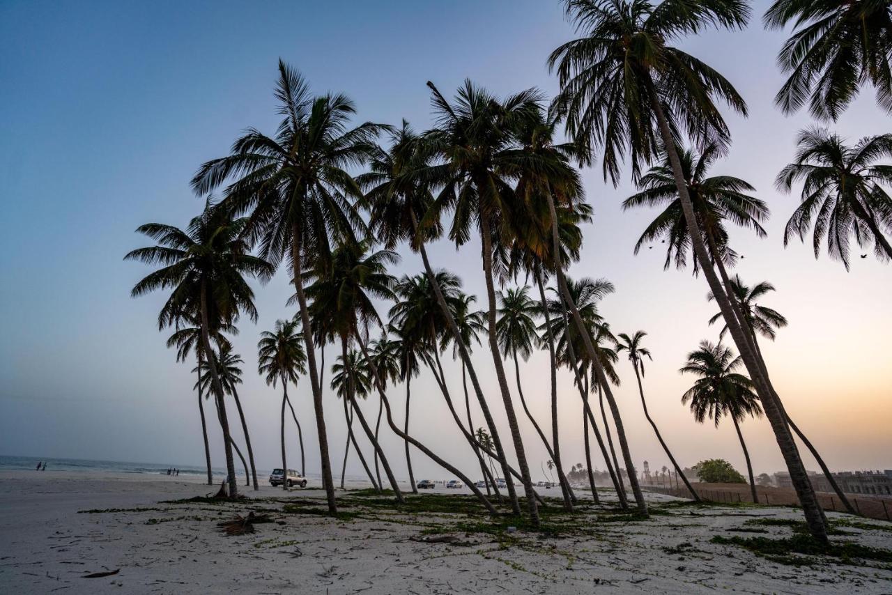 Fanar Hotel & Residences Salála Exteriér fotografie Palm trees on the beach of Awutu